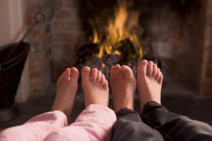 Children's feet warming at a fireplace